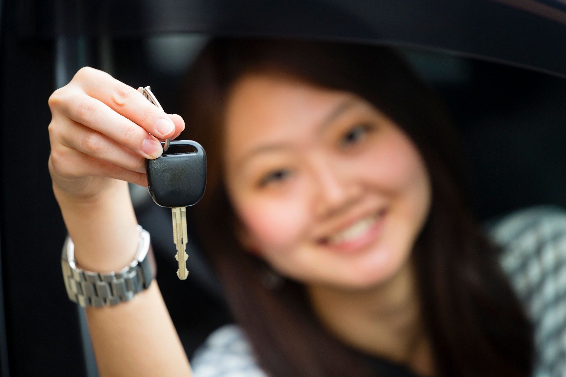 Pretty Japanese Woman Driving a Car